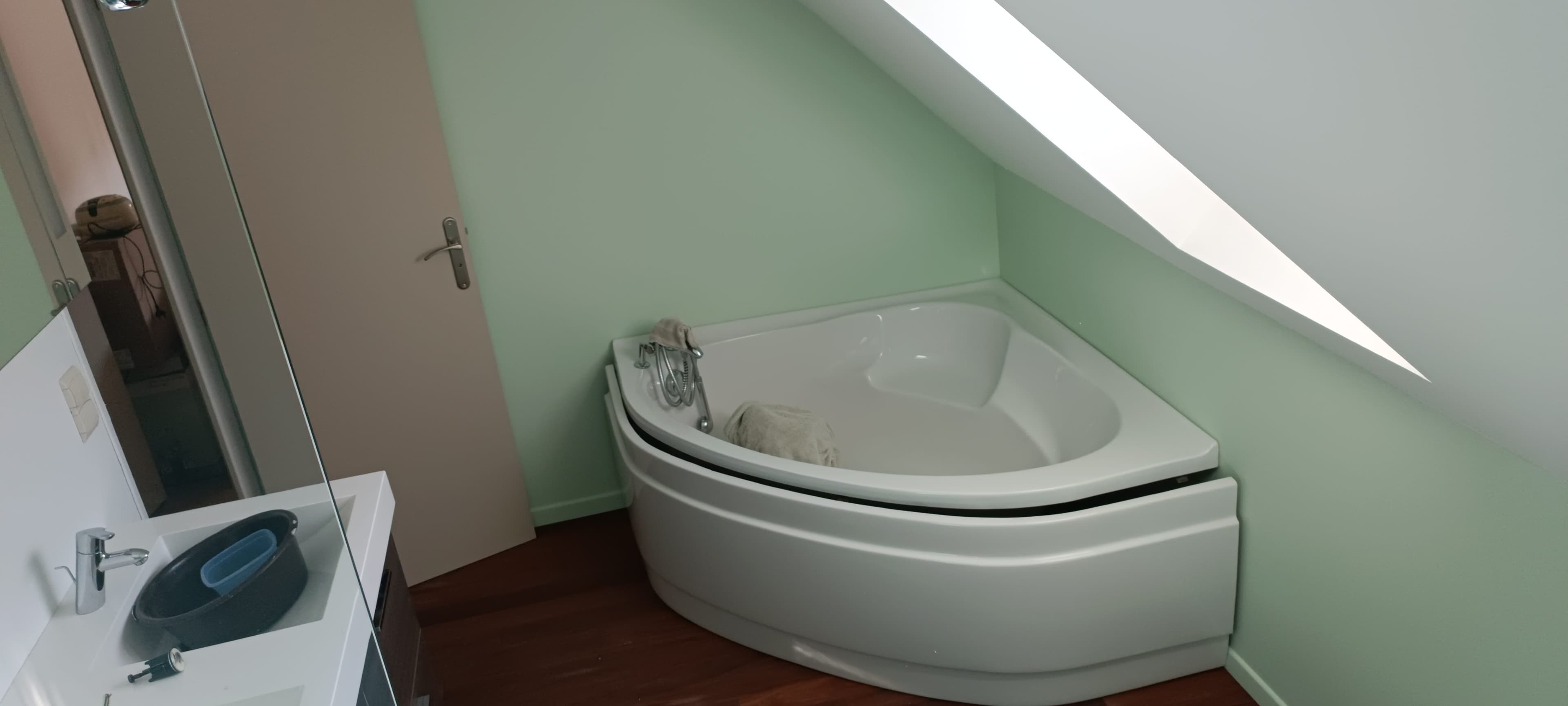 Salle de bain sous combles aux murs vert d'eau